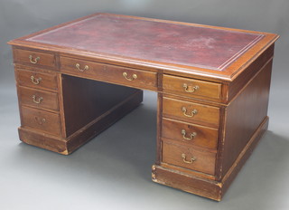 A mahogany partners desk with inset red leather writing surface, fitted 2 long and 2 short drawers, the base fitted 6 drawers and cupboards 29"h x 60"w x 41 1/2"d 