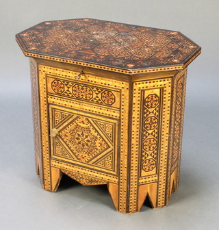 A Moorish style octagonal inlaid hardwood work table with hinged lid, the base fitted a cupboard enclosed by a panelled door 22"h x 22 1/2"w x 15"d 
