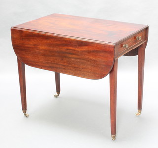 A 19th Century mahogany Pembroke table fitted a drawer and raised square tapered supports, brass caps and casters 29" x 34" x 21" x  41 1/2" when open 
