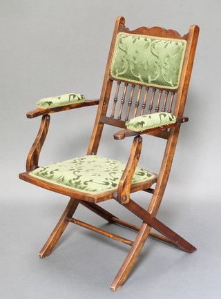 A Victorian beech framed folding campaign armchair with bobbin turned decoration 