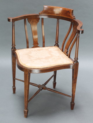 An Edwardian inlaid mahogany bar back corner chair raised on turned supports with X framed stretcher 
