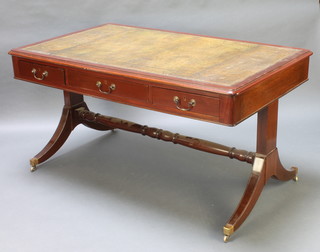 A Regency style rectangular mahogany library table with green inset writing surface fitted 3 drawers and raised on splayed supports with turned stretcher 30"h x 58"w x 34"d 
