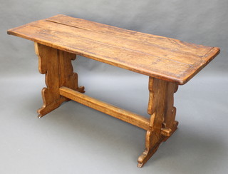 A rustic oak refectory dining table, the top formed from 3 planks and raised on standard end supports with H framed stretcher 29 1/2" x 62 1/2"l  x 24"w 