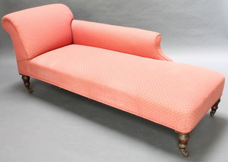 A late Victorian chaise longue upholstered in pink and gold material on turned supports 29"h x 73"l x 26"w 