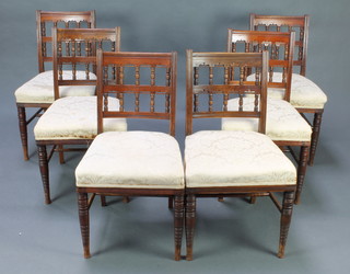 A set of 6 Victorian aesthetic movement walnut ladder back dining chairs with bobbin turned decoration and upholstered seats, raised on turned supports 