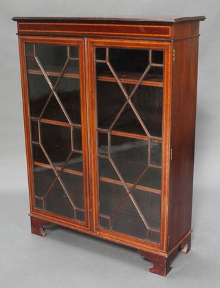 An Edwardian inlaid mahogany bookcase fitted shelves enclosed by astragal glazed panelled doors raised on bracket feet 48"h x 36"w x 13 1/2"d 