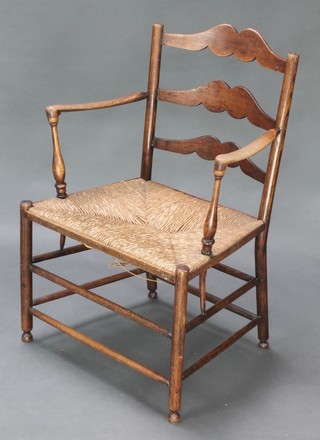 An 18th Century elm ladder back carver chair with woven rush seat, raised on turned supports 