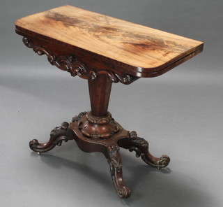 An early Victorian carved mahogany D shaped games table with carved apron raised on chamfered column and shaped base, raised on splayed supports 29" x 34" x 17" 
