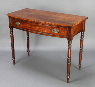 A 19th Century mahogany bow front side table fitted a drawer, raised on turned supports 30 1/2" x 40" x 20" 