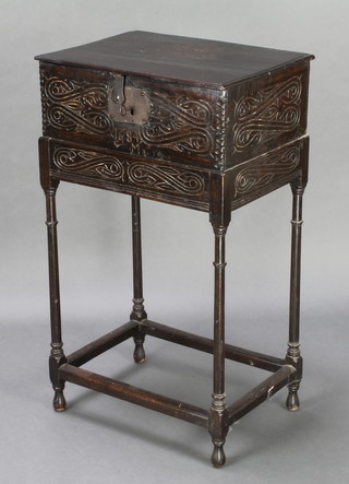 A 17th/18th Century carved oak bible box with hinged lid and iron lock, the interior fitted a candle box, marked 1684, raised on a later associated stand 35 1/2"h x 21" x 14 1/2"  