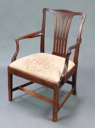 A Georgian mahogany slat back carver chair with upholstered drop in seat, raised on square supports with box frame stretcher