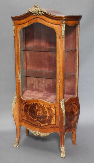A shaped Kingwood vitrine with gilt metal mounts, fitted adjustable shelves enclosed by panelled door, raised on cabriole supports 65"h x 29 1/2"w x 15"d 