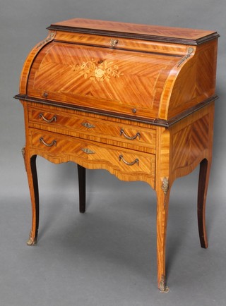 An inlaid Kingwood cylinder bureau, the interior fitted a recess flanked by a pair of cupboards and 3 drawers, the base fitted 2 long drawers raised on cabriole supports with gilt metal mounts 40"h x 29 1/2"w x 18"d 
