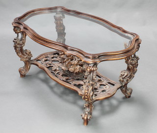 An oval resin and carved wooden occasional table with glass top, the pierced undertier decorated a basket of flowers raised on cabriole supports 19"h x 38"w x 22"d 
