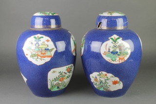 A pair of 19th Century Chinese baluster vases and covers, the blue and gilt decorated ground with panels of flowers, figures in pavilion gardens and motifs 13 1/2" 