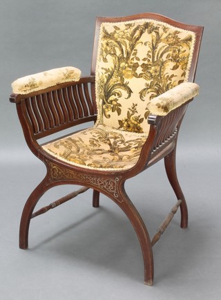 An Edwardian inlaid rosewood and brass X framed armchair, the seat and back upholstered in floral velour