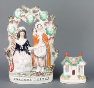A Victorian Staffordshire money bank in the form of a cottage with bocage 4 1/2", do. figure group - Fortune Teller 12" 