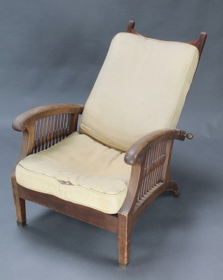 An Art Nouveau walnut ladder back reclining armchair with brass cappings, the back marked Regd 485275