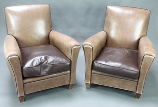 A pair of club style armchairs upholstered in brown leather 