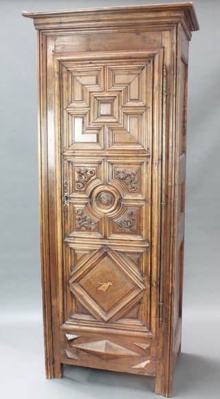 A 17th/18th Century Continental carved oak armoire with moulded cornice, part fitted shelves enclosed by a geometrically moulded panelled door 77 1/2"h x 32 1/2"w x 22"d 