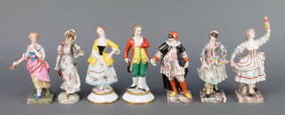 A set of 4 Italian figures of ladies and gentlemen, 2 wearing masks and 3 other Continental figures 