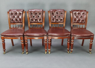 A set of 4 Victorian mahogany dining chairs the backs upholstered in buttoned brown leather material, raised on reeded supports 