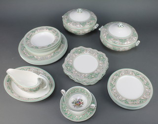 A Wedgwood Florentine green pattern dinner service comprising 6 dessert plates, 6 dinner plates, 5 bowls, 2 tureens and covers, gravy boat, an oval bowl, 6 fruit plates 
