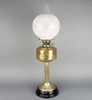 A Victorian etched glass oil lamp reservoir raised on a reeded brass column 