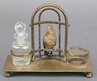 A rectangular gilt metal 2 bottle stand, the centre decorated an Austrian cold painted bronze figure of a cockatoo 4 1/2" x 6" x 3 1/2"