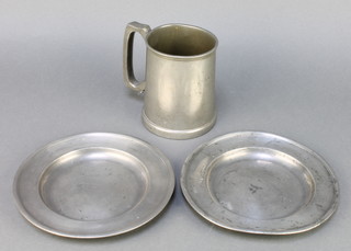 A pair of 19th Century pewter plates with London touch marks 7" (1 with light corrosion) together with a 1930's glass bottom pewter tankard marked St Anthony's Sports 1934 