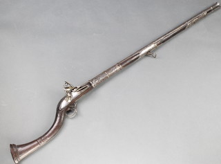 An Indian flintlock musket with 33" polished steel barrel and ram rod, the barrel with white engraving and having a shaped wooden carved stock (the lock with East India Company mark) 
