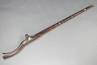 An Indian flintlock musket with ram rod, the lock plate with East India Company mark and dated 1815, 53"