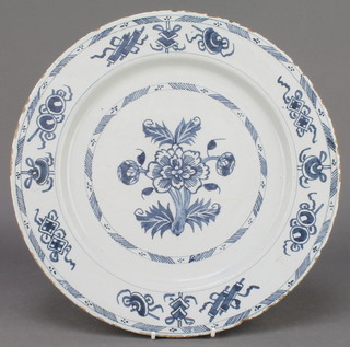 An 18th Century English blue and white Delft ware plate decorated with stylised flowers, the rim with motifs 18" 