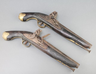A pair of reproduction flintlock pistols with 9" barrels, ramrods, 1 lock marked Tower 