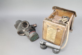 A Second World War Civil Defence respirator and a field telephone no.100 (Mk234) 