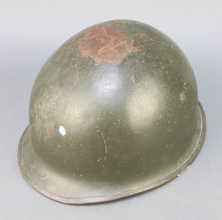 An American steel helmet complete with liner, the interior marked OO74 9131 