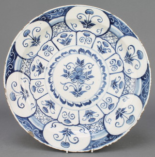 An 18th Century English blue and white Delft ware plate, the centre with a stylised flower surrounded by panels of flowers 14" 