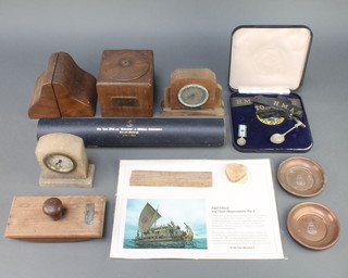 A square tobacco jar formed from timber of a silver grain elm taken from the foundation of Waterloo bridge 1805-1936 4" x 4 1/2" x 4 1/2", a blotter formed from wood of HMS Vindictive 1915, a thermometer mounted in a teak case formed from teak of HMS Birmingham, a pair of book ends from wood of HM Queen Victoria's Royal Yacht Alberta together with an HMS Hermes cap tally, an HMAS Rockhampton  etc 