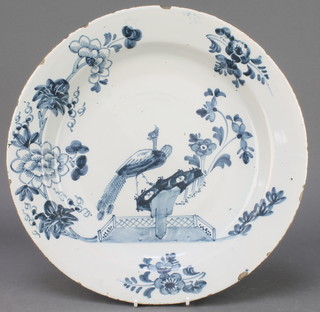 An 18th Century English blue and white Delft ware shallow bowl, the centre decorated with a peacock enclosed by flowers and leaves 13 1/2" 