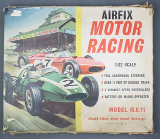 An Airfix motor racing game complete with 2 cars boxed, a Dinky Super Toy tank transporter no. 660, various Corgi Police vehicles and other vehicles 