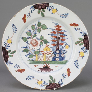 An 18th Century English polychrome Delft ware plate, the centre decorated with stylised tree and flowers with a floral border 14" 