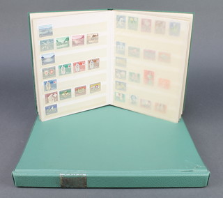 A green album stock book of Switzerland stamps 1854-1964 