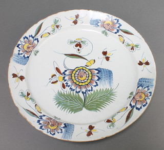 An 18th Century English polychrome Delft ware charger decorated with flowers and insects in a similar border  13 1/2" diam. 