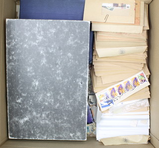 A box file containing loose World stamps, 2 albums of World stamps and various stamped envelopes