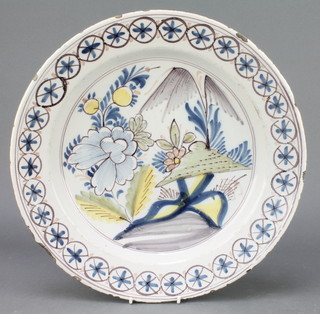 An 18th Century English polychrome Delft ware shallow bowl decorated with stylised flowers within a geometric border 13 1/2" 
