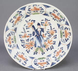 An unusual 18th Century English Delft ware polychrome plate decorated with a semi-clad lady amongst flowers enclosed in a stylised floral border 14" 