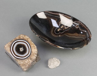 An oval polished agate bowl 2 1/2" x 8 1/2" x 6" and 2 polished sections of agate 4" x 3" x 2" and 1 1/2" x 1" 