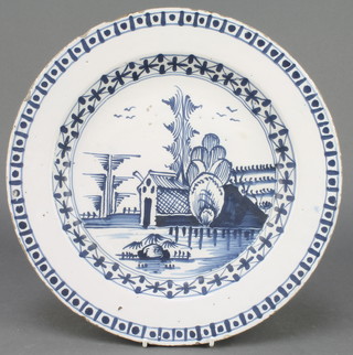 An 18th Century English blue and white Delft ware plate with landscape view and birds enclosed in a geometric border 12" 