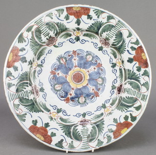 An 18th Century English polychrome Delft ware shallow dish the centre with stylised flowers enclosed in a formal floral border 13 1/2" 