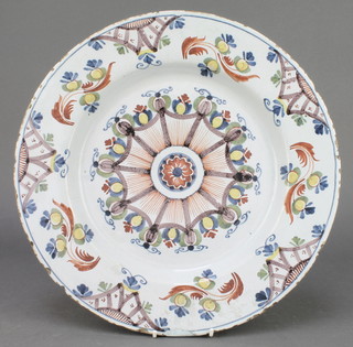 An 18th Century English polychrome Delft ware shallow dish with geometric centre enclosed by scrolling flowers 13 1/2" 